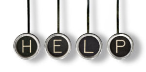 Four old, scratched chrome typewriter keys with black centers and white letters spelling out "HELP". With drop shadow, isolated on white.